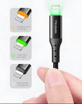 Black iPhone charging cable with dual-colour LED lights showing orange and green charging indicators