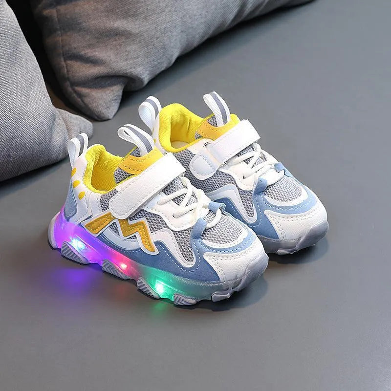 Kids' black light-up sneakers with mesh panels, Velcro strap, and glowing LED lights in the sole.