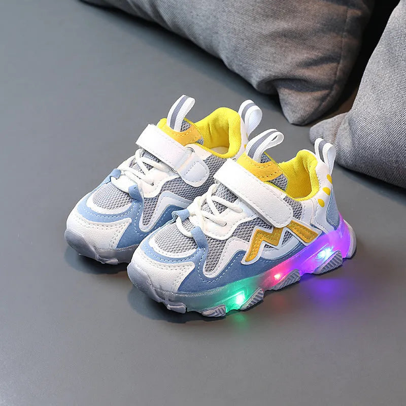 Kids' black light-up sneakers with mesh panels, Velcro strap, and glowing LED lights in the sole.