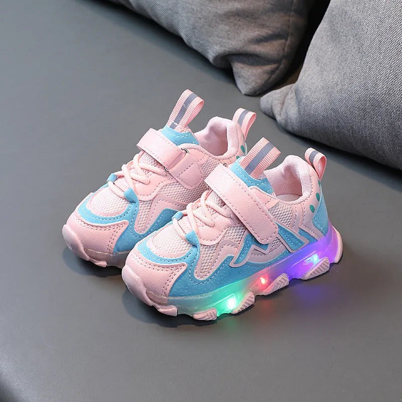 Kids' black light-up sneakers with mesh panels, Velcro strap, and glowing LED lights in the sole.
