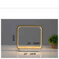 Modern white smart bedside lamp with touch base and USB cable on a wooden nightstand.