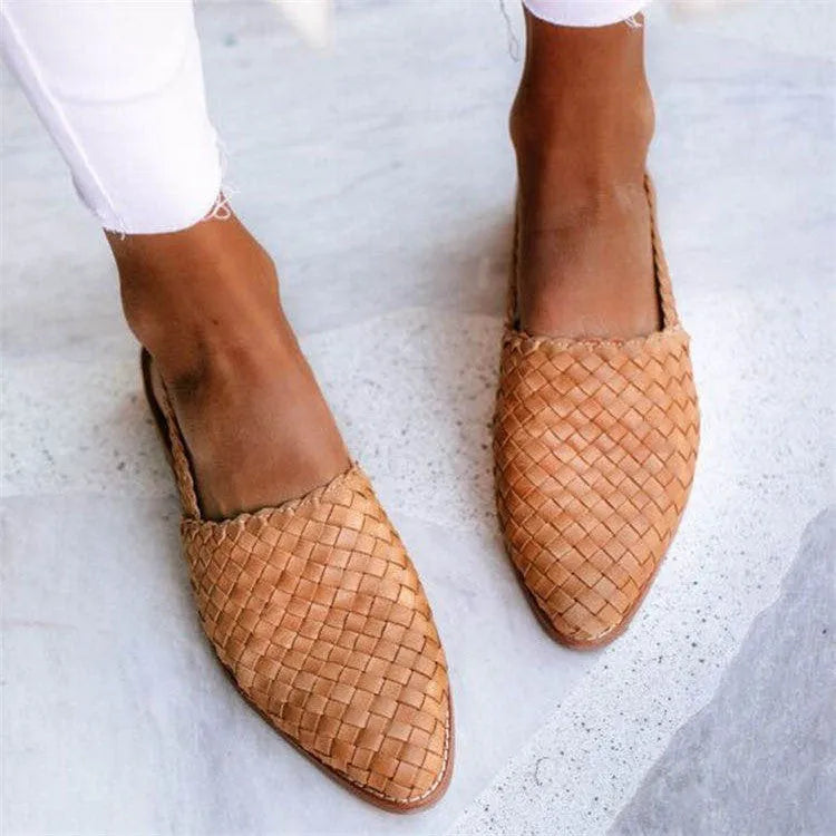 Pointed-toe flat casual sandals with a buckle strap on a microfiber upper and rubber sole.
