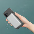 Silver aluminium magnetic wireless charging power bank, shown next to a mobile phone, displaying slim 12mm profile.