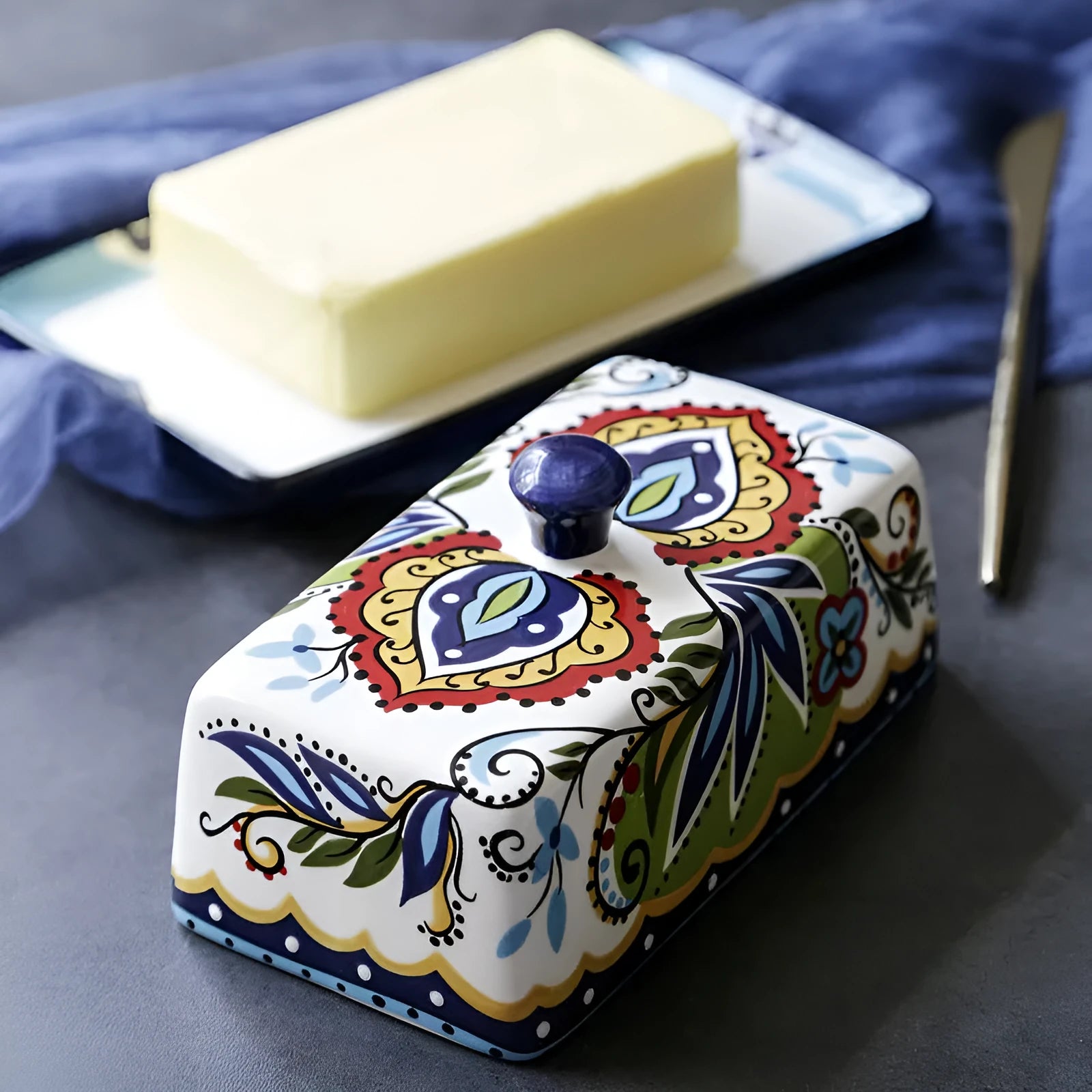 Square ceramic butter box with floral pattern and lid, shown in blue colour.