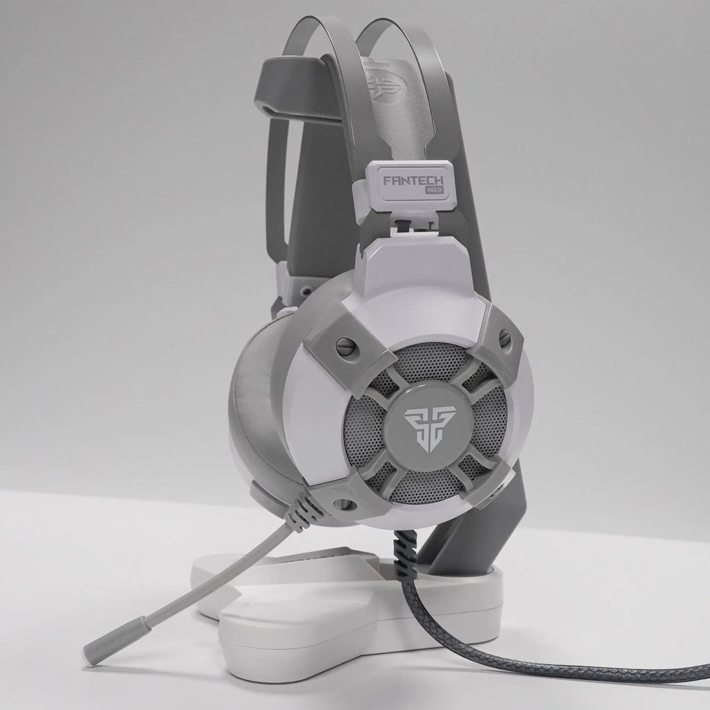 Black FANTECH HG11 USB gaming headset with large ear cups, RGB lighting, and an inline remote control on the cable.