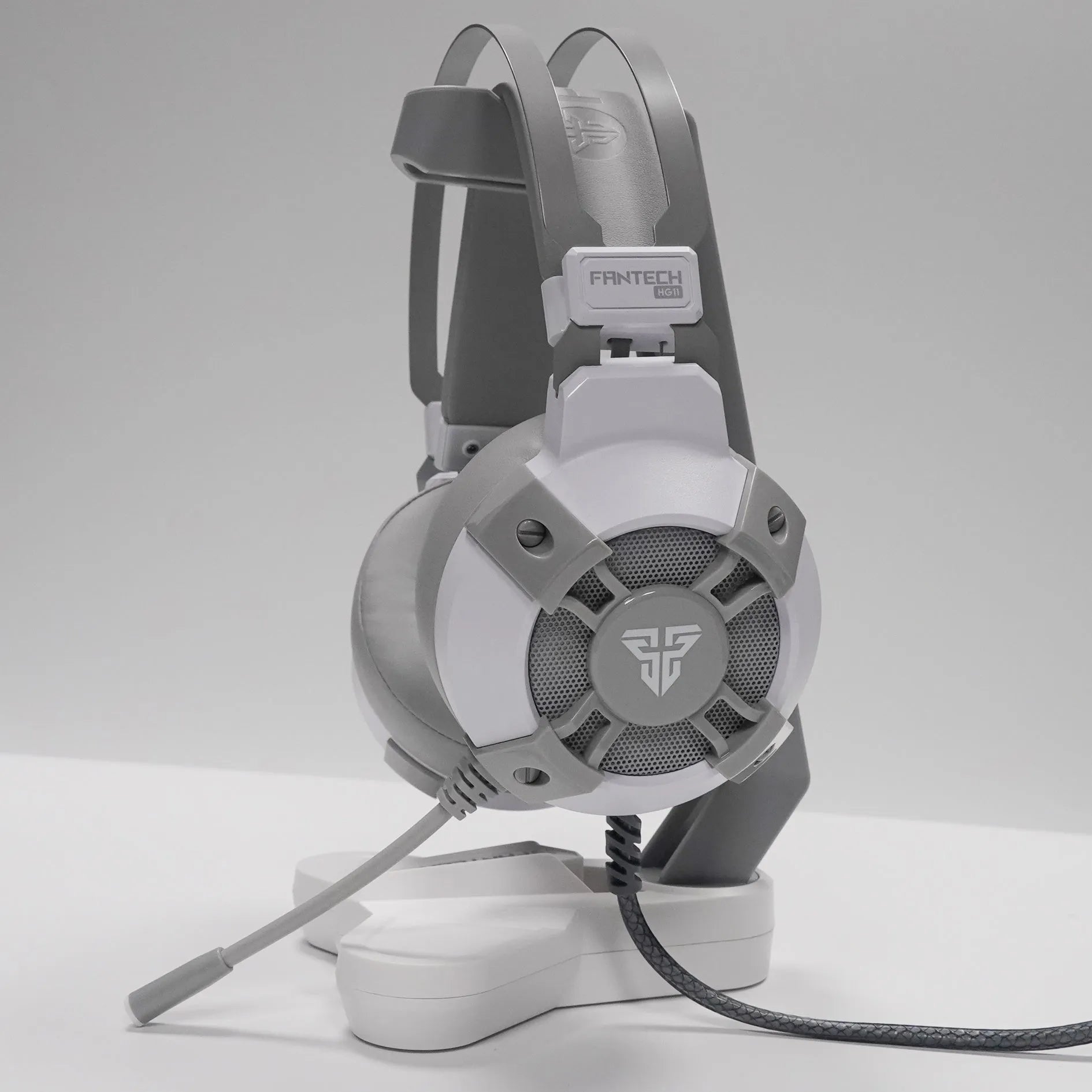 Black FANTECH HG11 USB gaming headset with large ear cups, RGB lighting, and an inline remote control on the cable.