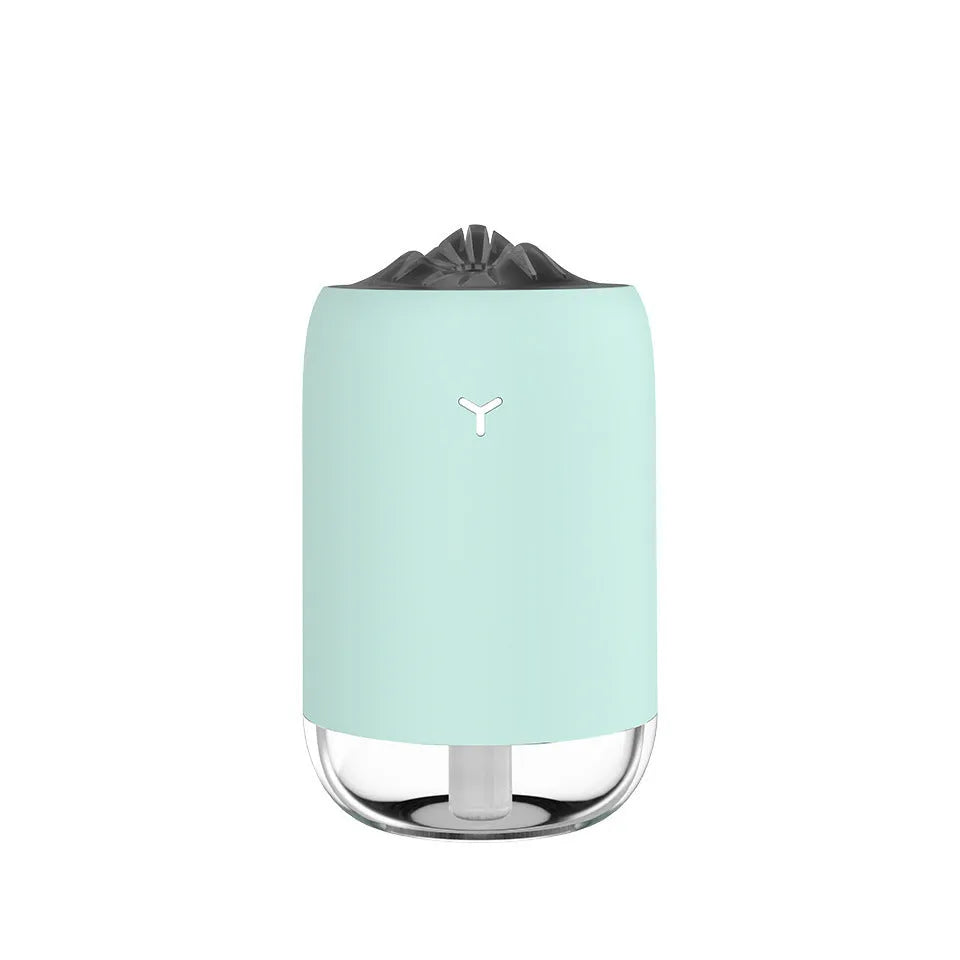 White Magic Flame columnar humidifier with USB cable on a desk