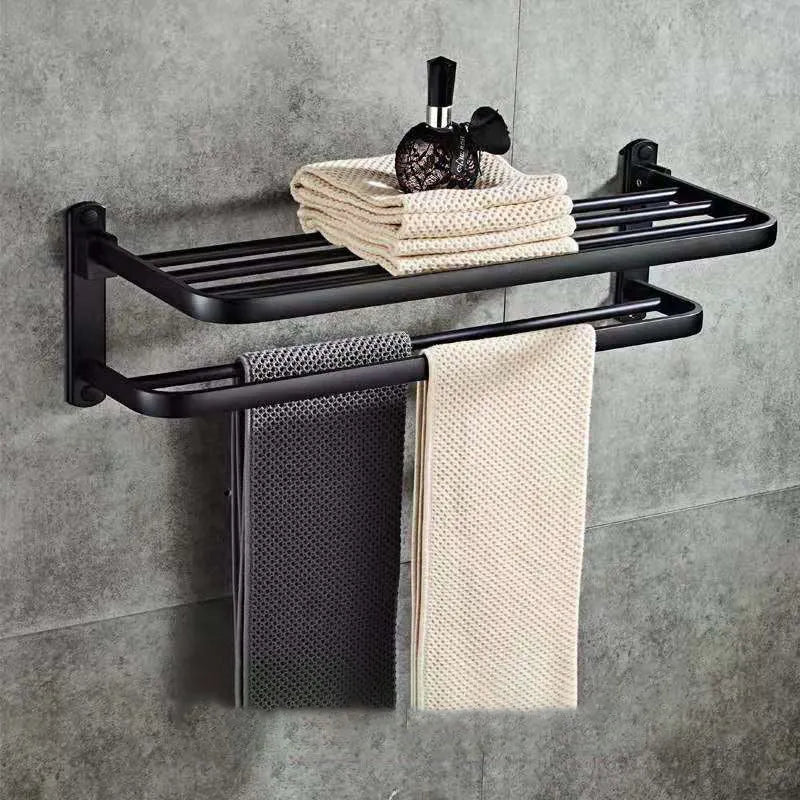 Aluminium double-layer folding shelf mounted on a bathroom wall with towels.