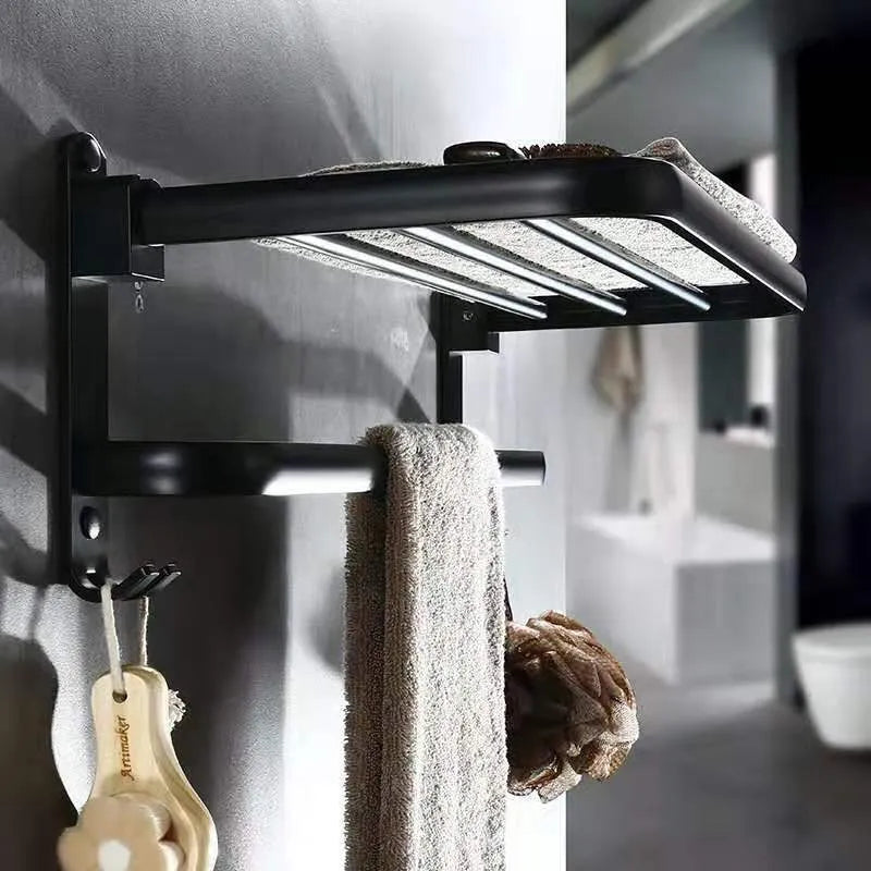 Aluminium double-layer folding shelf mounted on a bathroom wall with towels.