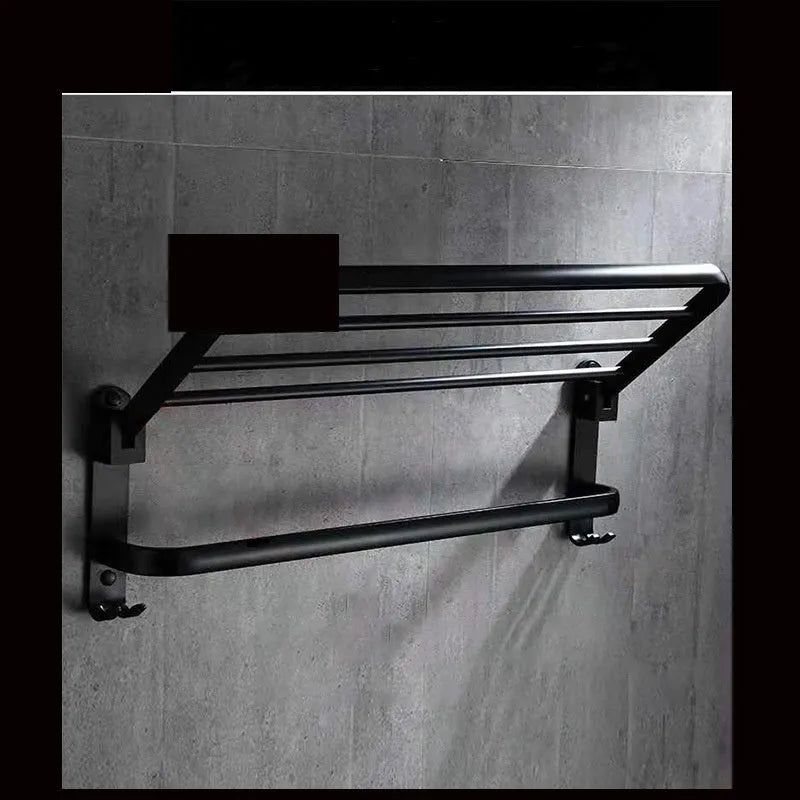 Aluminium double-layer folding shelf mounted on a bathroom wall with towels.