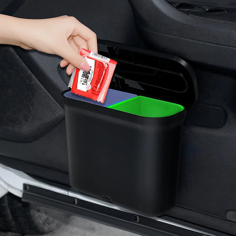 Black 1.7L PP plastic car trash can suspended on centre console with lid open, interior visible