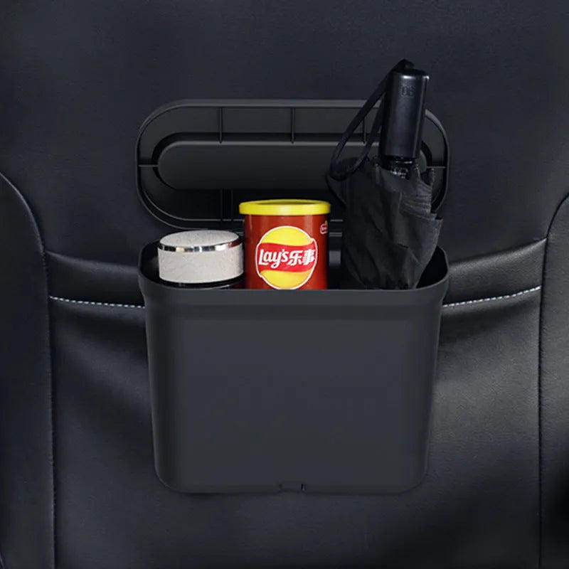 Black 1.7L PP plastic car trash can suspended on centre console with lid open, interior visible