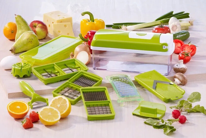 Green handheld manual food chopper with stainless steel blades on a white background.