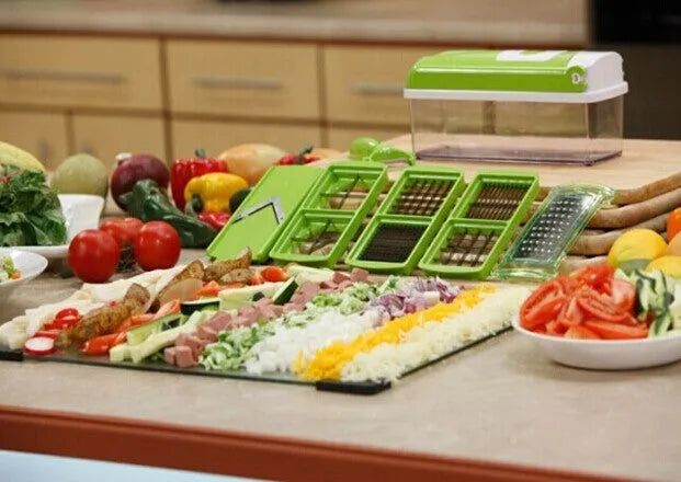 Green handheld manual food chopper with stainless steel blades on a white background.