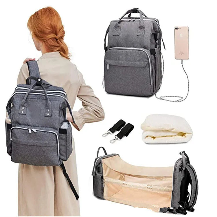 Large shell-shaped polyester mummy bag in black with three shoulder straps and soft handle
