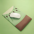 Green kiwi fruit printed on large cloth mouse pad with a raised grey silicone wrist support attached.