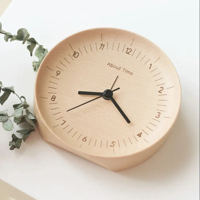 AboutTime log mute pendulum alarm clock in German beech wood, 12cm diameter, featuring Sun brand movement, on a simple desk