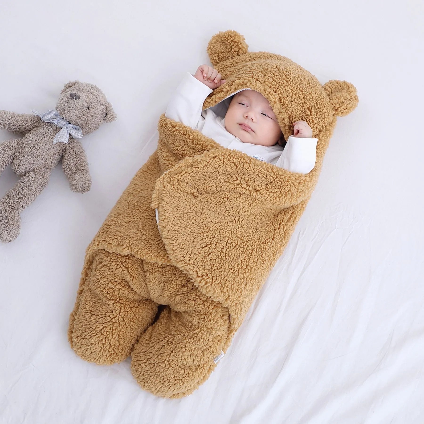 Cotton blend baby quilted sleeping bag wrapper shown in light blue, with size and colour options displayed.