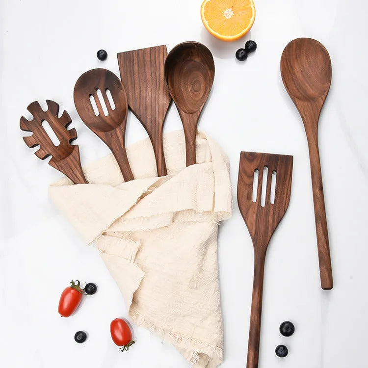 Six-piece black walnut wooden kitchen utensil set with spoon, spatula, slotted spoon and spaghetti claws