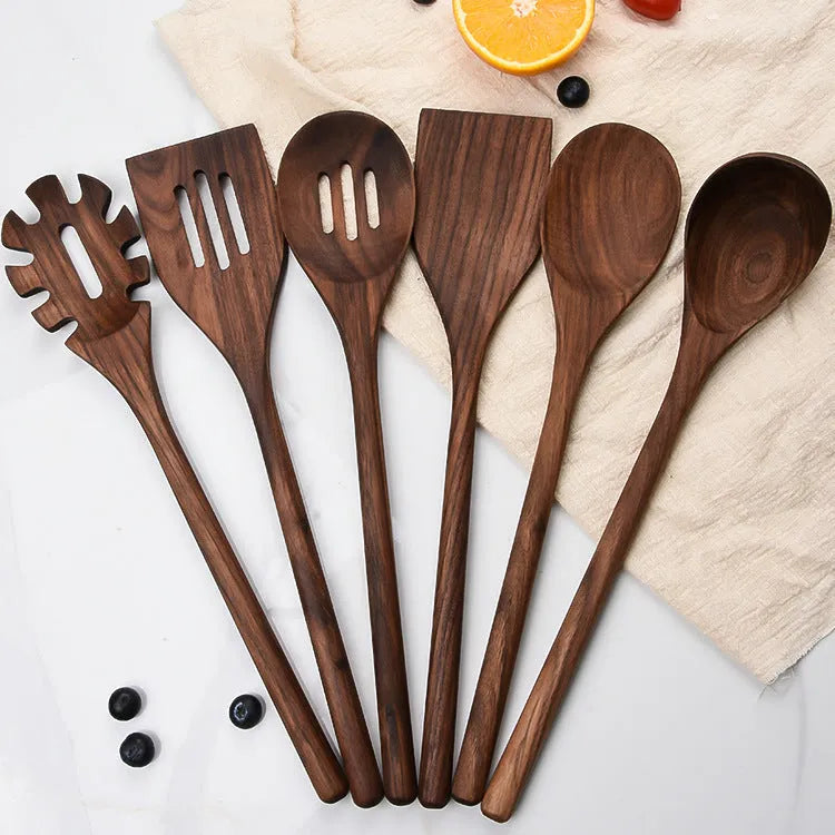 Six-piece black walnut wooden kitchen utensil set with spoon, spatula, slotted spoon and spaghetti claws