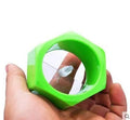 Yellow and green plastic spiral vegetable cutter for slicing cucumbers on a kitchen worktop.