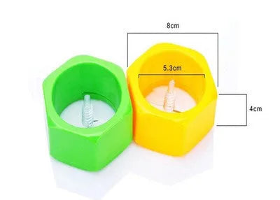 Yellow and green plastic spiral vegetable cutter for slicing cucumbers on a kitchen worktop.