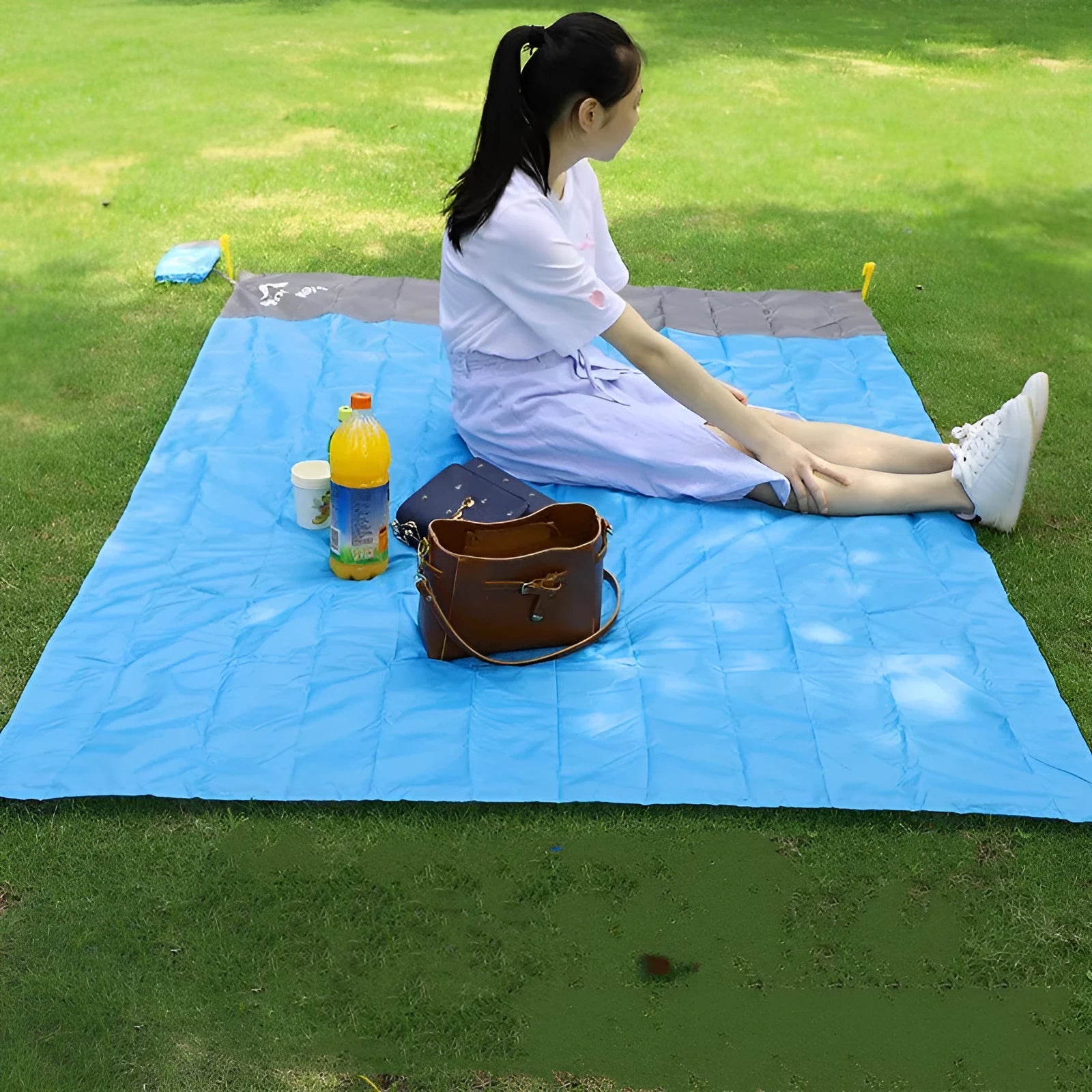 Blue and grey waterproof camping mat 2m x 2.1m with TPU coating, pegs, and storage sack on grass
