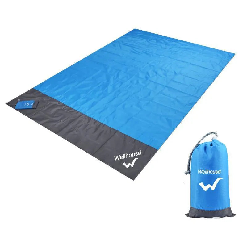Blue and grey waterproof camping mat 2m x 2.1m with TPU coating, pegs, and storage sack on grass