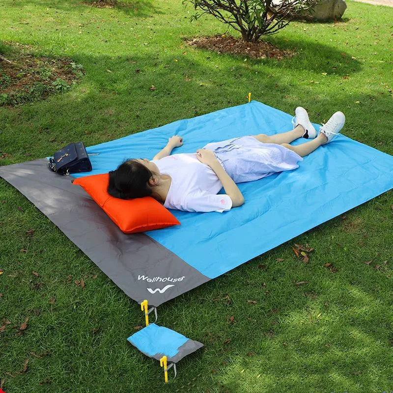 Blue and grey waterproof camping mat 2m x 2.1m with TPU coating, pegs, and storage sack on grass