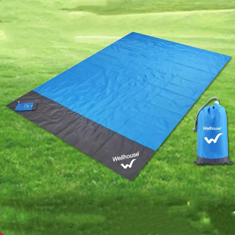 Blue and grey waterproof camping mat 2m x 2.1m with TPU coating, pegs, and storage sack on grass