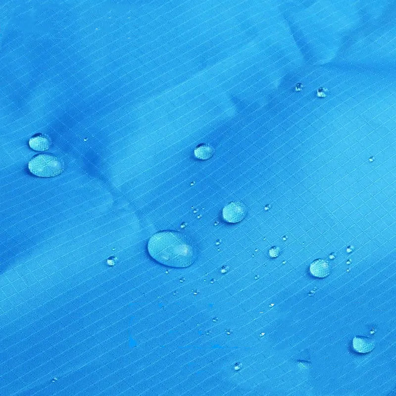 Blue and grey waterproof camping mat 2m x 2.1m with TPU coating, pegs, and storage sack on grass