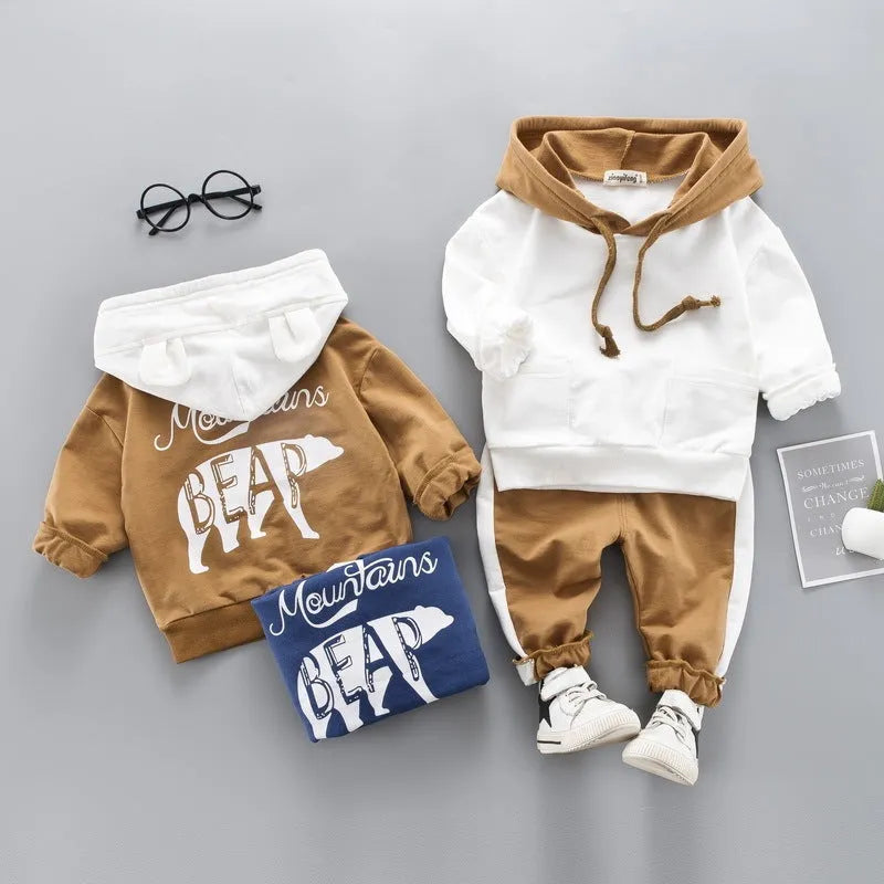 Child's blue two-piece hooded tracksuit set with top and trousers on white background