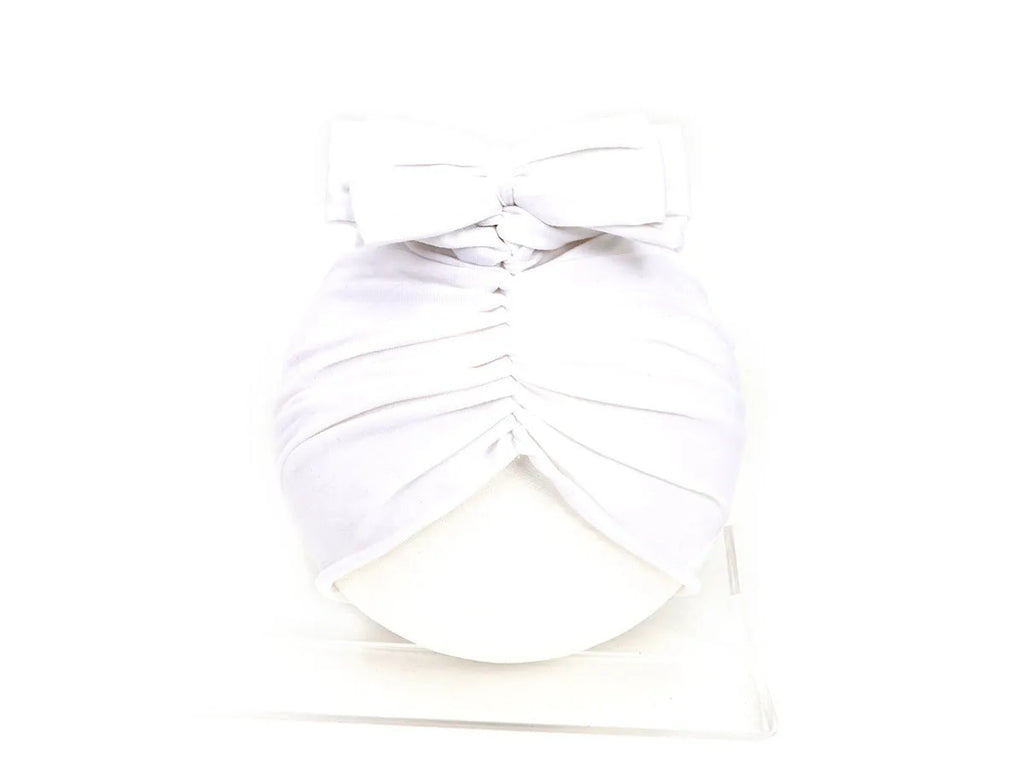 Soft knitted acrylic baby turban hat for newborns to toddlers in a solid colour.