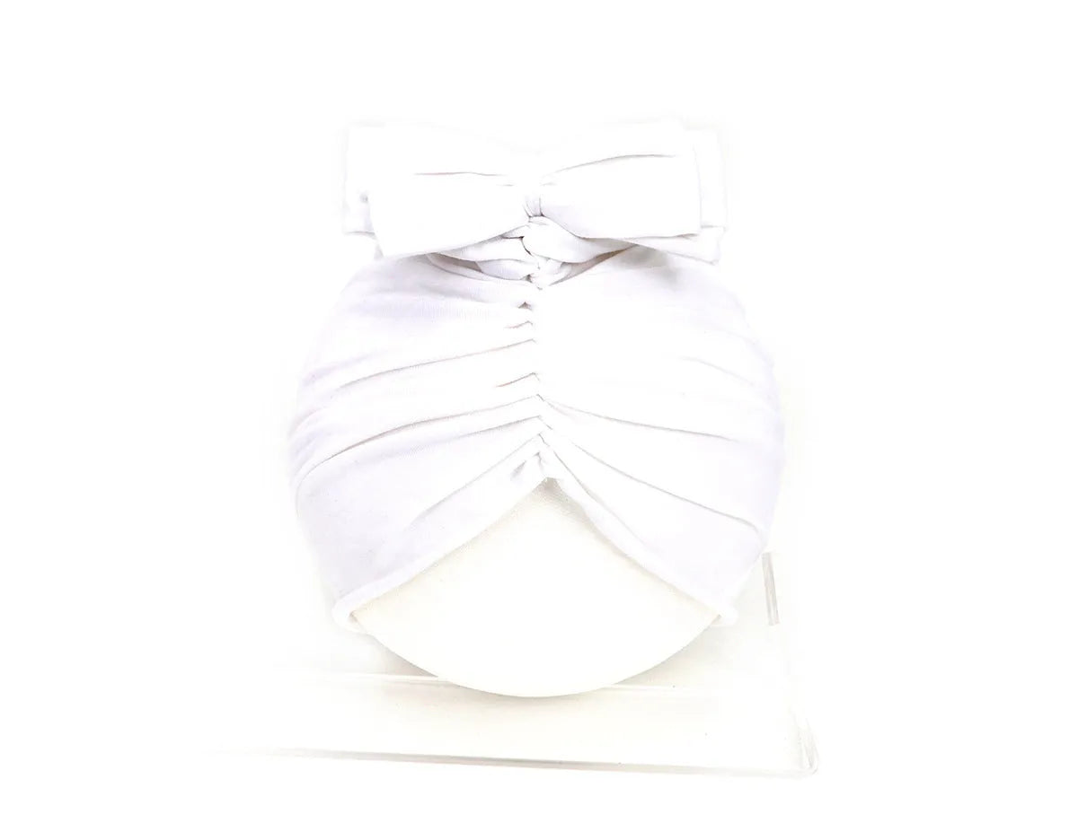 Soft knitted acrylic baby turban hat for newborns to toddlers in a solid colour.