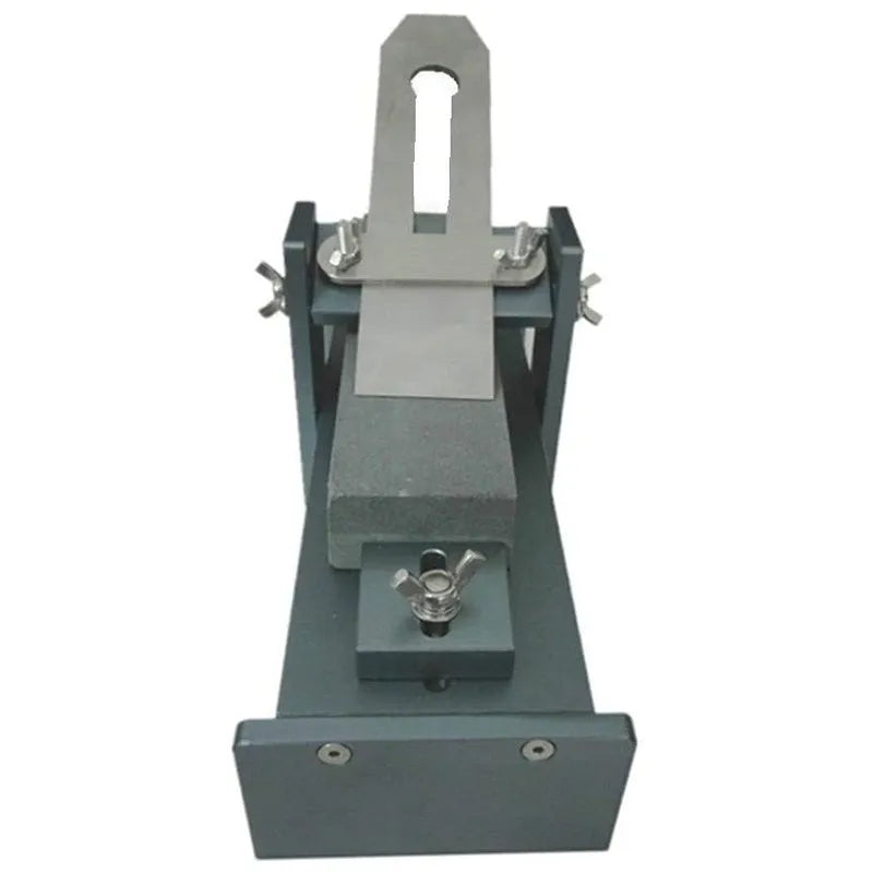 Fixed angle sharpening tool for woodworking chisels and carving knives on a workbench.