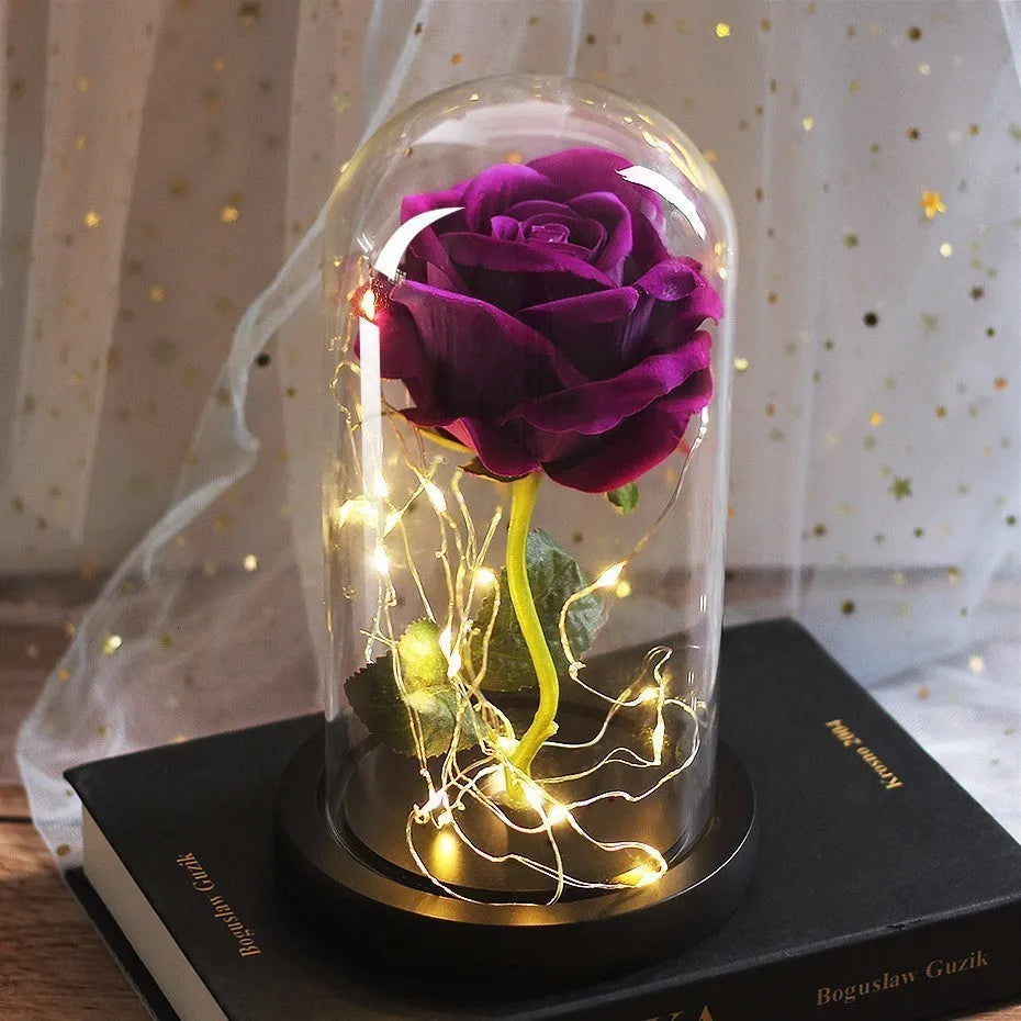 LED rose bouquet with glass lampshade showing warm white lights on simulation silk flowers.