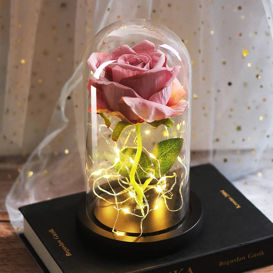 LED rose bouquet with glass lampshade showing warm white lights on simulation silk flowers.