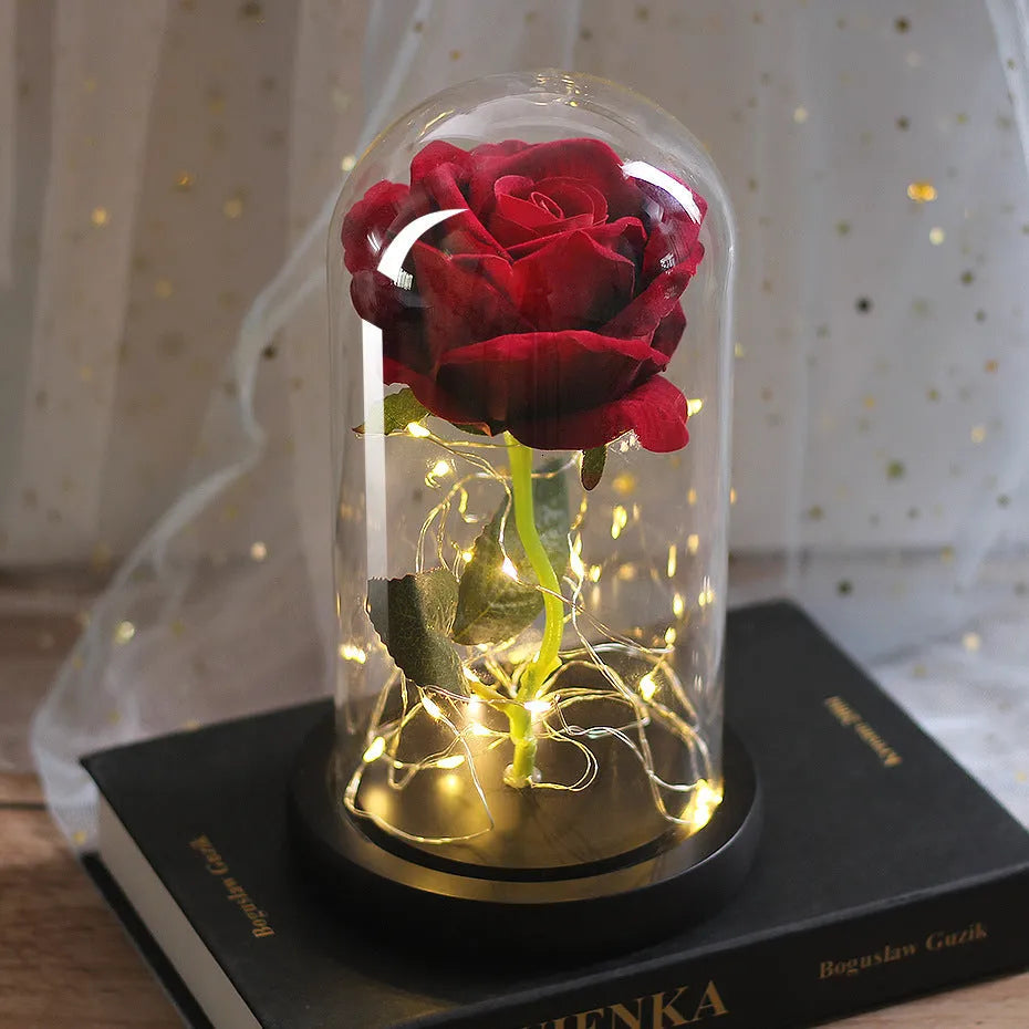 LED rose bouquet with glass lampshade showing warm white lights on simulation silk flowers.