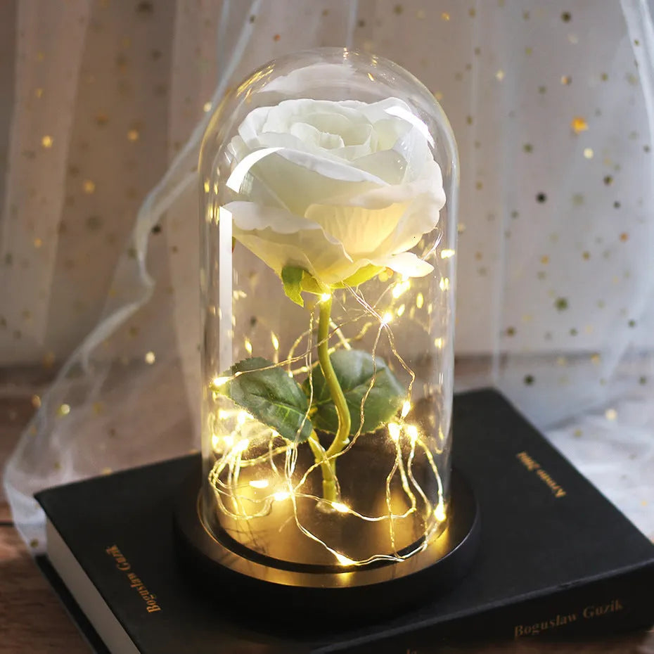 LED rose bouquet with glass lampshade showing warm white lights on simulation silk flowers.