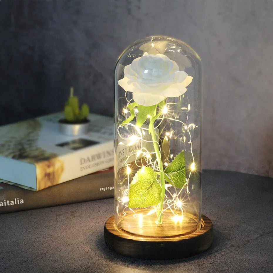 LED rose bouquet with glass lampshade showing warm white lights on simulation silk flowers.