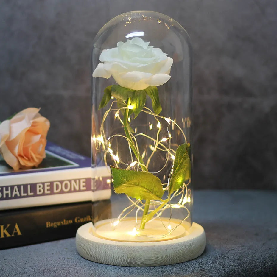 LED rose bouquet with glass lampshade showing warm white lights on simulation silk flowers.
