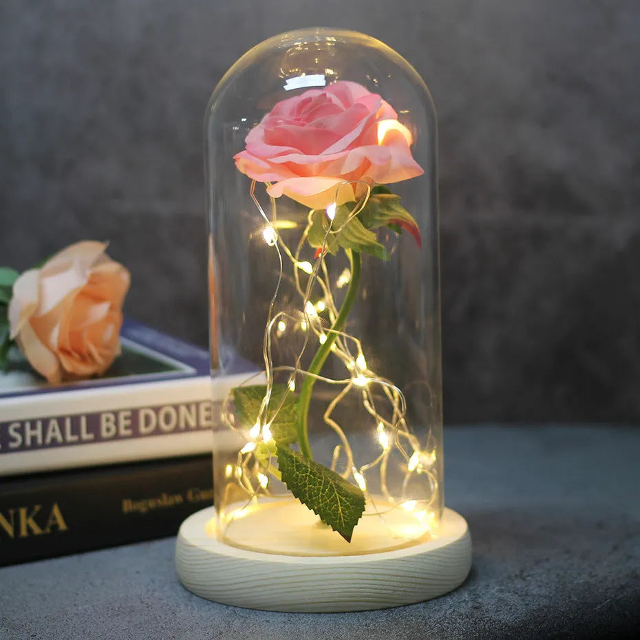LED rose bouquet with glass lampshade showing warm white lights on simulation silk flowers.
