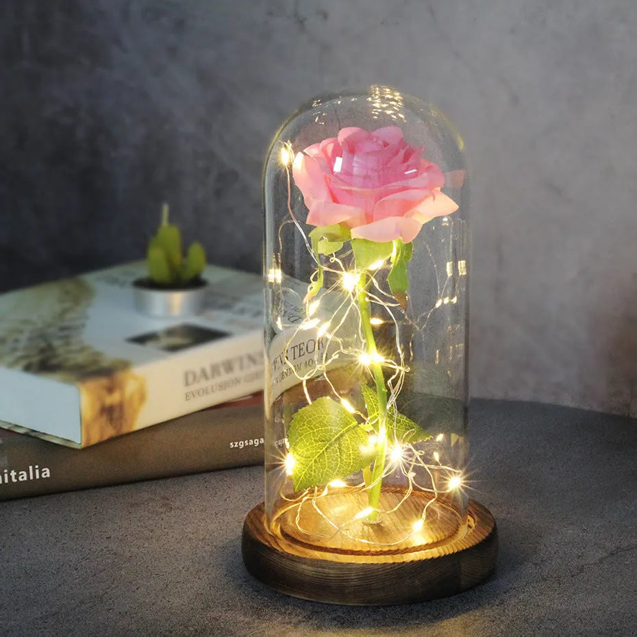LED rose bouquet with glass lampshade showing warm white lights on simulation silk flowers.