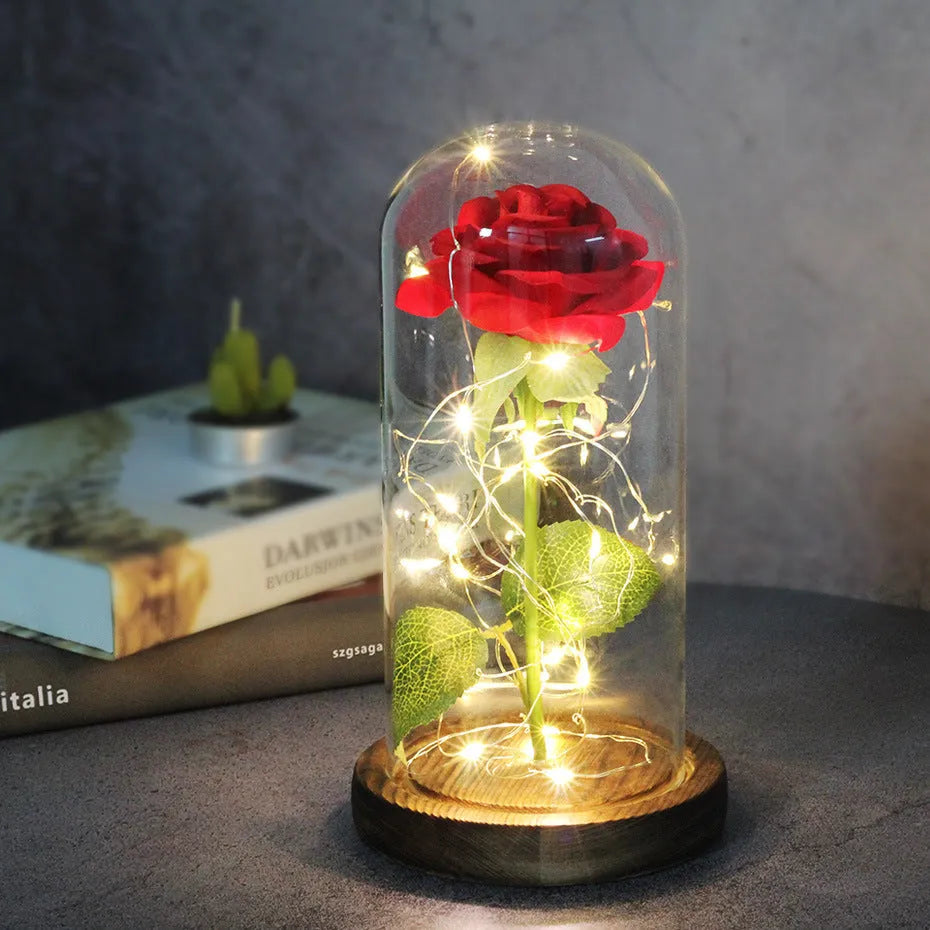 LED rose bouquet with glass lampshade showing warm white lights on simulation silk flowers.
