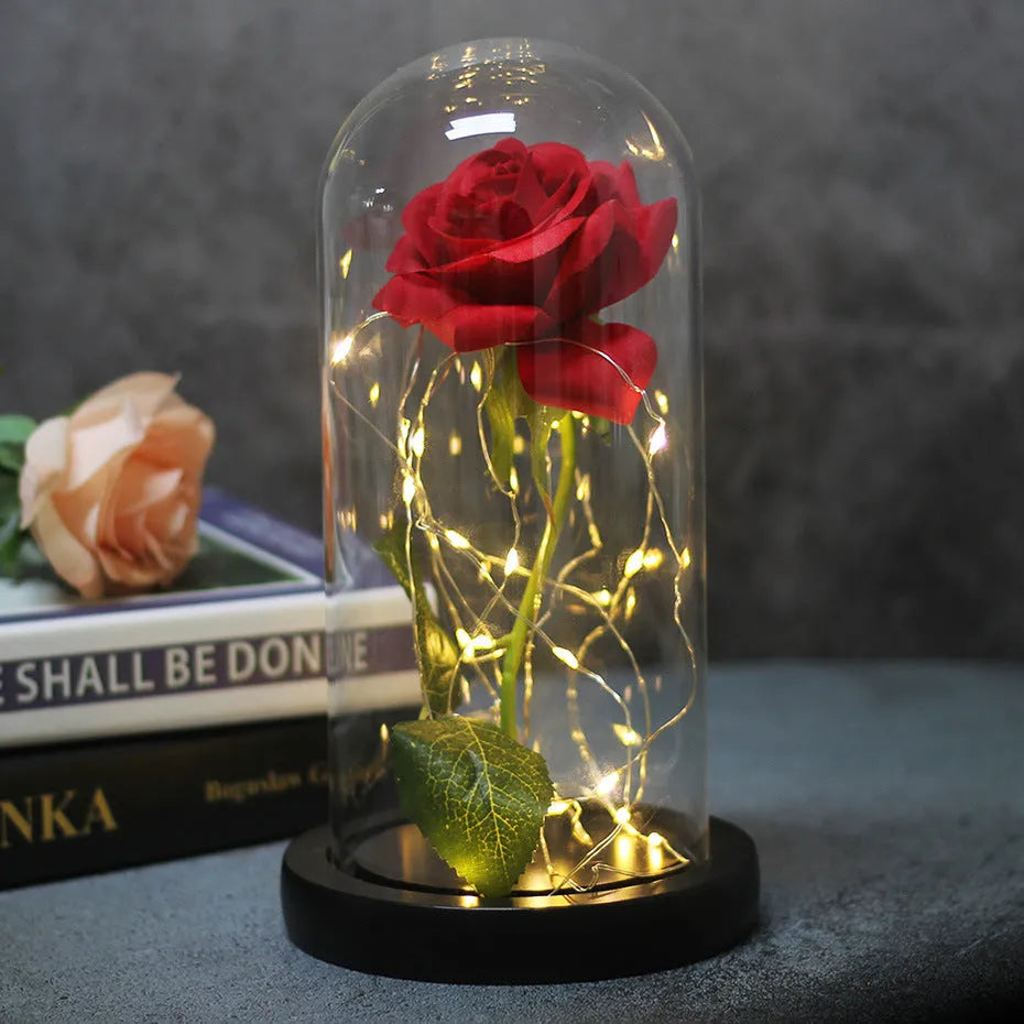 LED rose bouquet with glass lampshade showing warm white lights on simulation silk flowers.