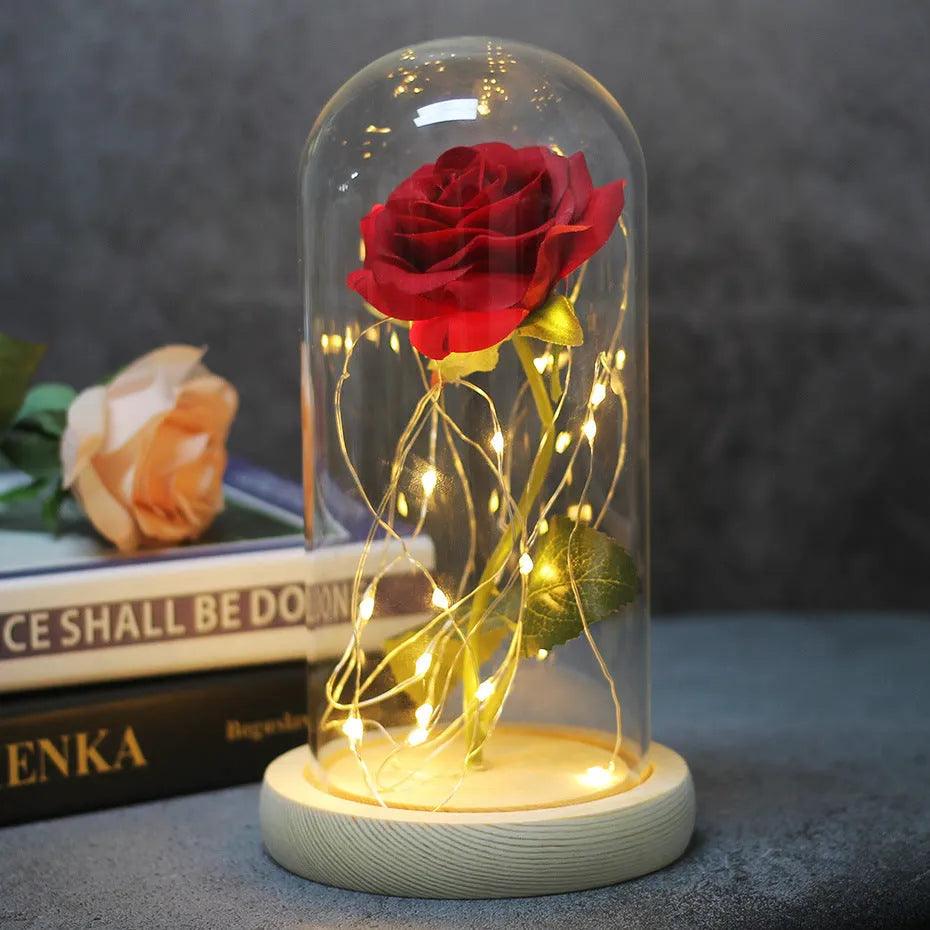 LED rose bouquet with glass lampshade showing warm white lights on simulation silk flowers.