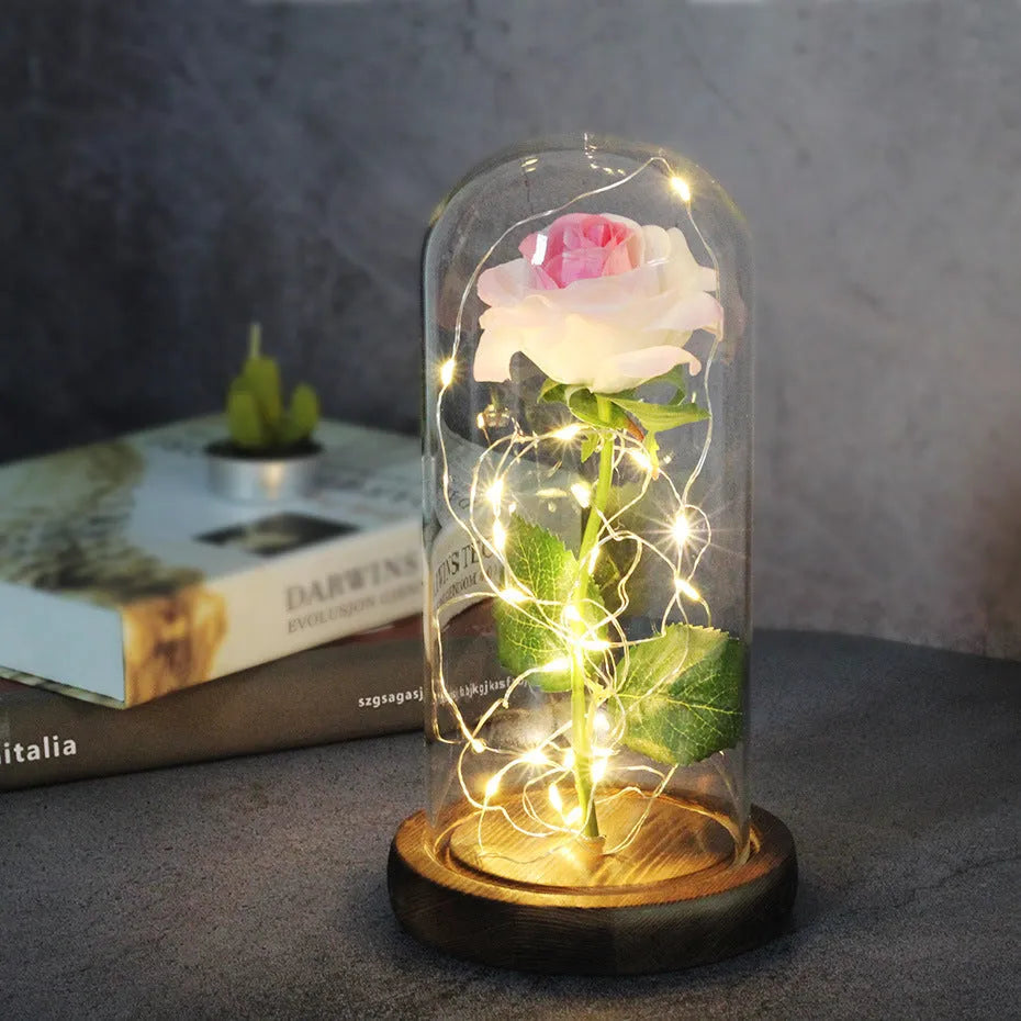 LED rose bouquet with glass lampshade showing warm white lights on simulation silk flowers.