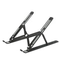 Aluminium alloy laptop heightening bracket folded flat on desktop, black colour, with portable storage base lifter design.
