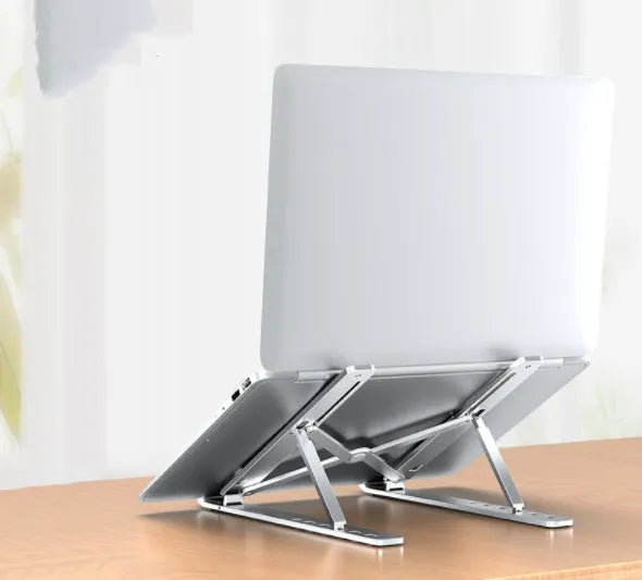 Aluminium alloy laptop heightening bracket folded flat on desktop, black colour, with portable storage base lifter design.
