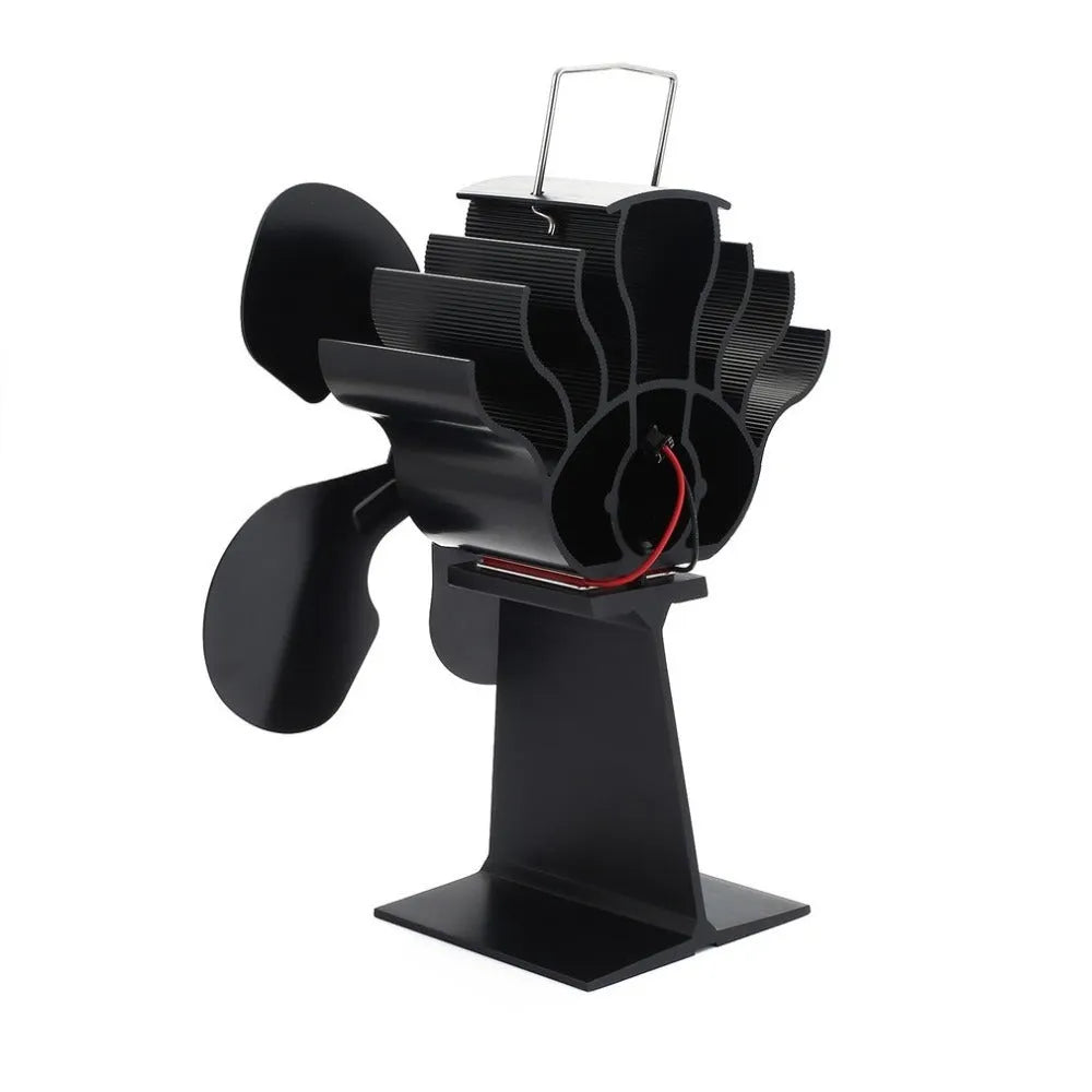 Black thermodynamic fireplace fan with Yotsuba style blades, placed on a fireplace surface